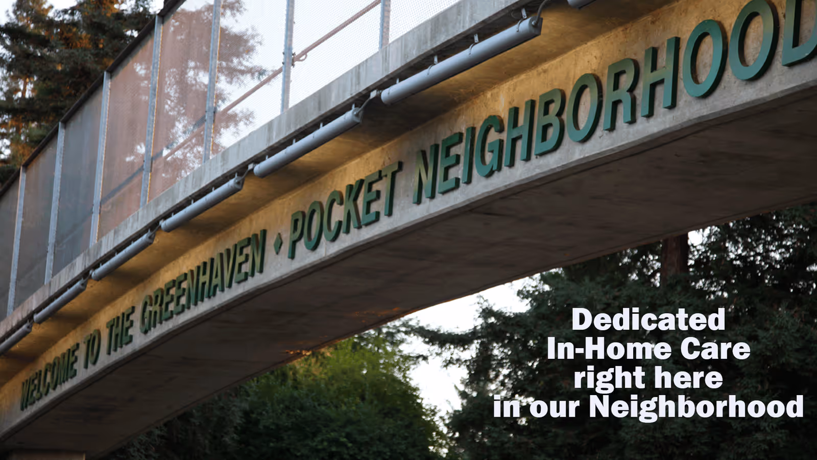 Exterior bridge sign reads Welcome to Greenhaven Pocket Neighborhood with care message on side.