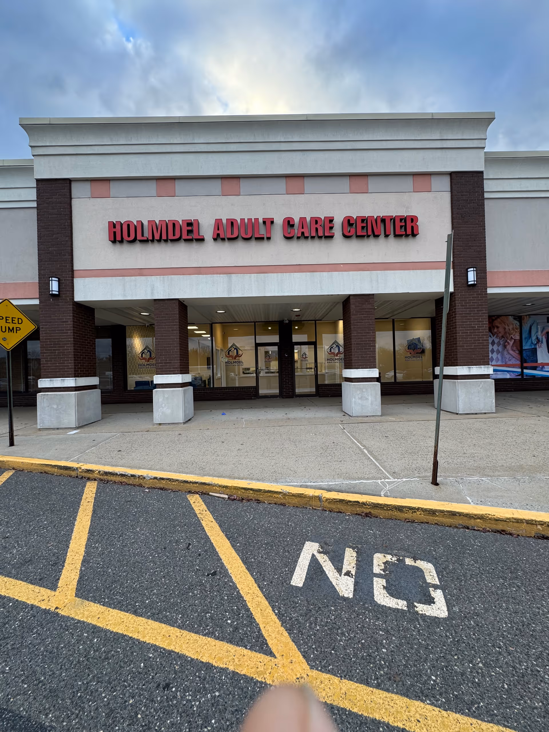Exterior front view of Holmdel Adult Care Center entrance and parking.