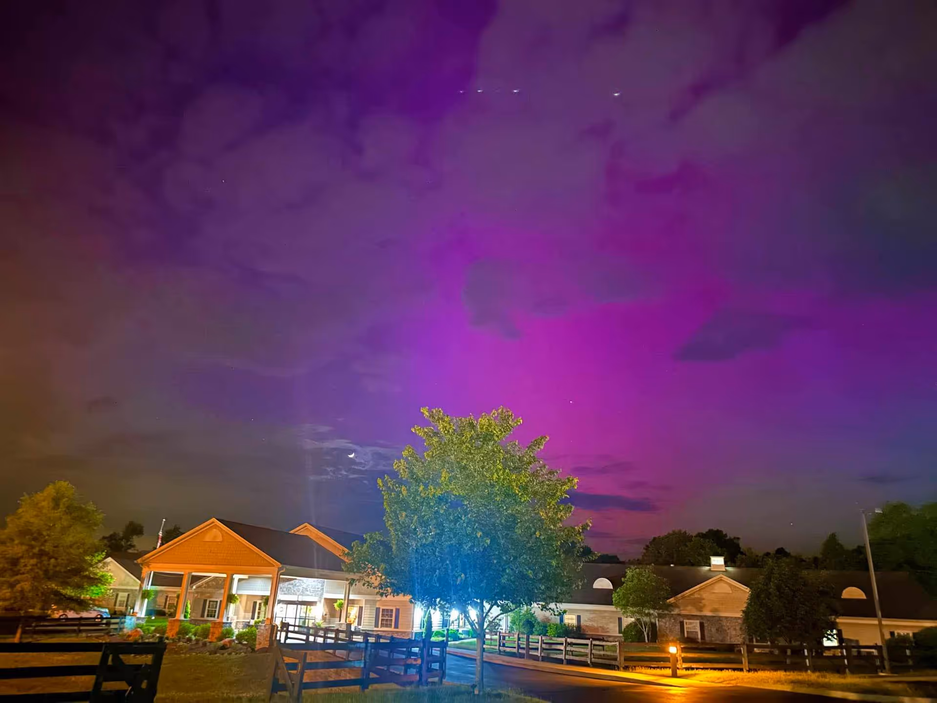 Exterior view of Morning Pointe of Frankfort at night with an illuminated entrance.