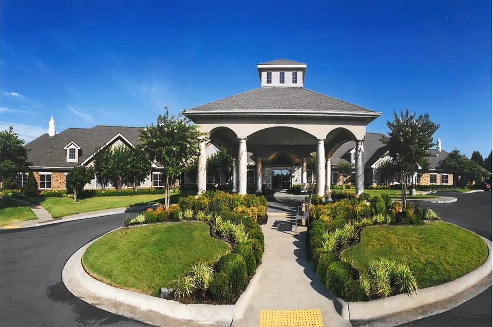 Exterior view of Ashley Rehabilitation and Health Care Center with landscaped circular drive and entrance arches.