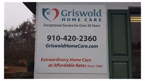 Outdoor sign advertising Griswold Home Care with contact number and website.