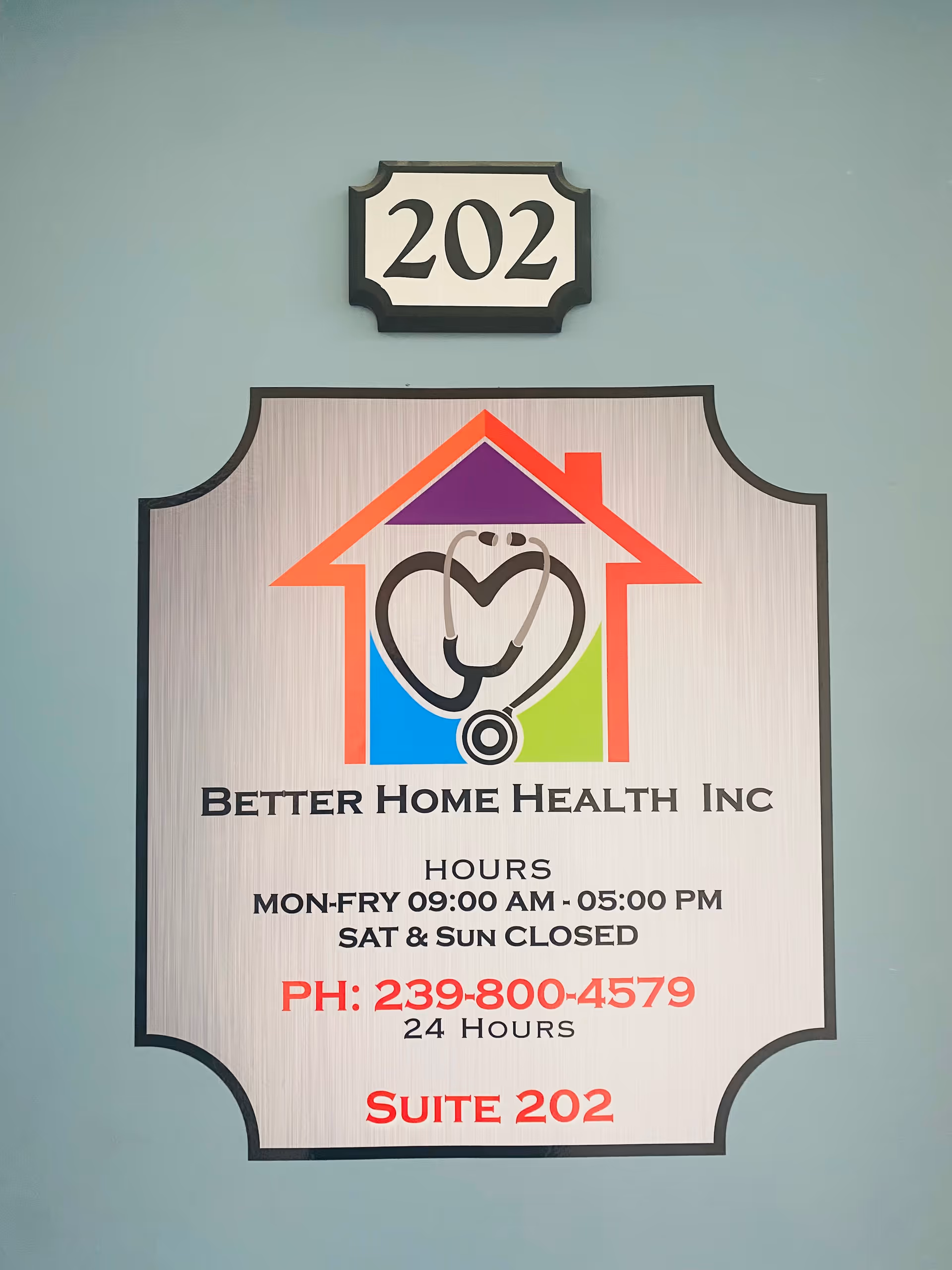 Exterior wall sign for Better Home Health Inc with logo, hours, and Suite 202.