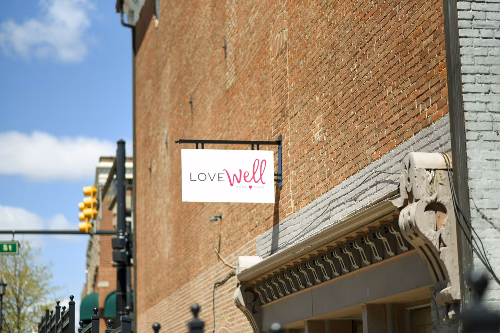Brick building exterior with a Lovewell Home Care sign and an awning.