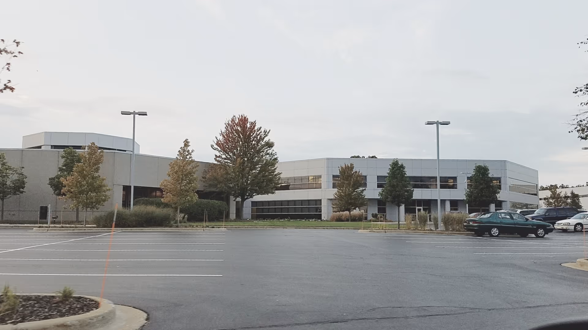 Exterior of Healthcare Services Corporation facility with parking lot and trees.
