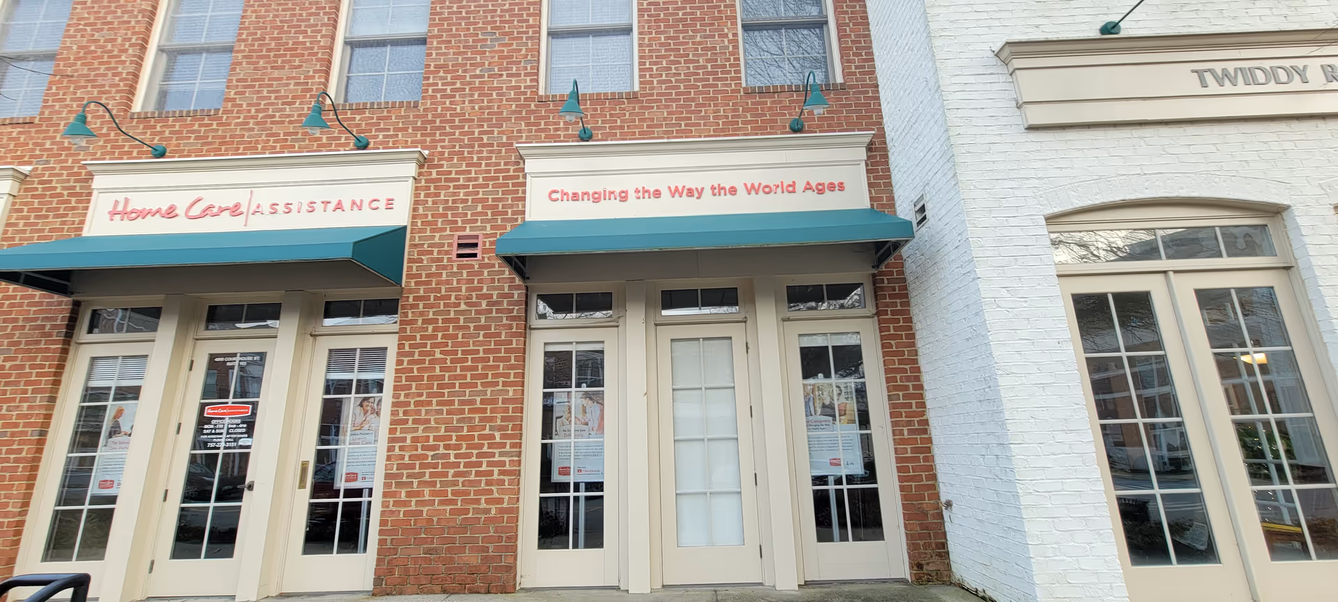 Exterior view of a brick building with Home Care Assistance storefront signage.