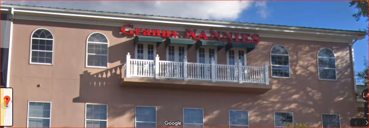 Front facade of Granny NANNIES senior home care facility with balcony and arches
