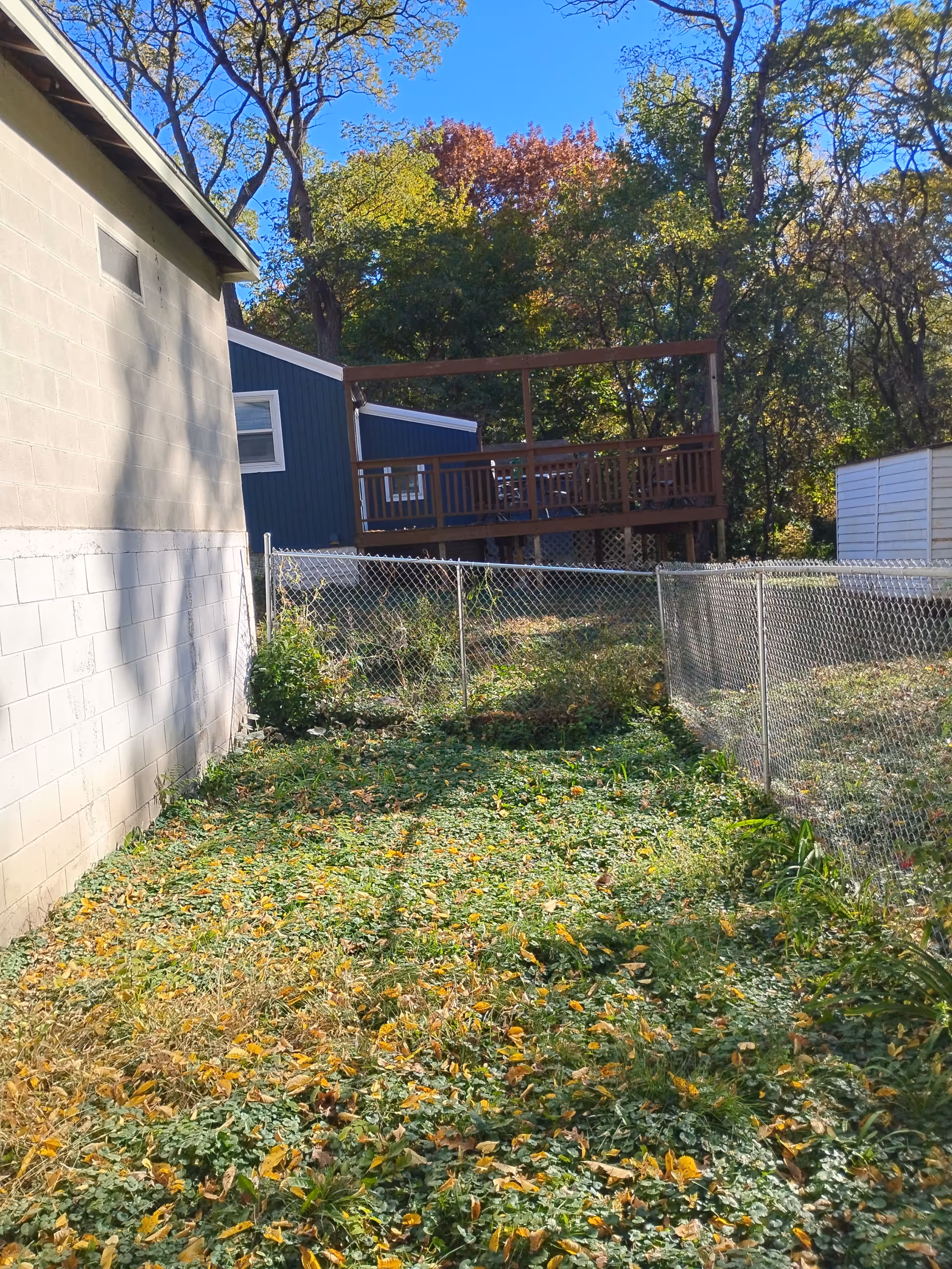 Outdoor area behind Affordable Home Health Care with a deck and chain-link fence.