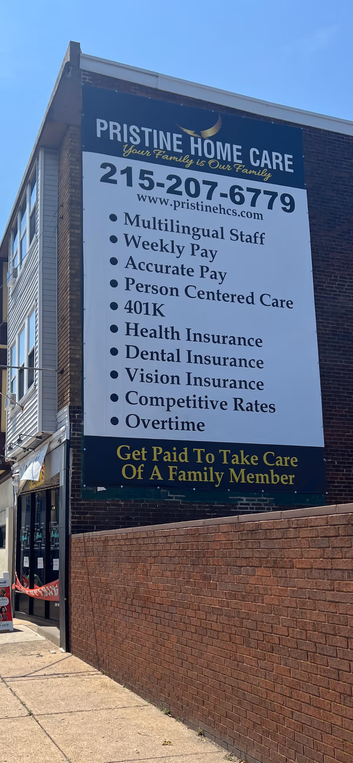 Large exterior sign on a brick building advertising Pristine Home Care.