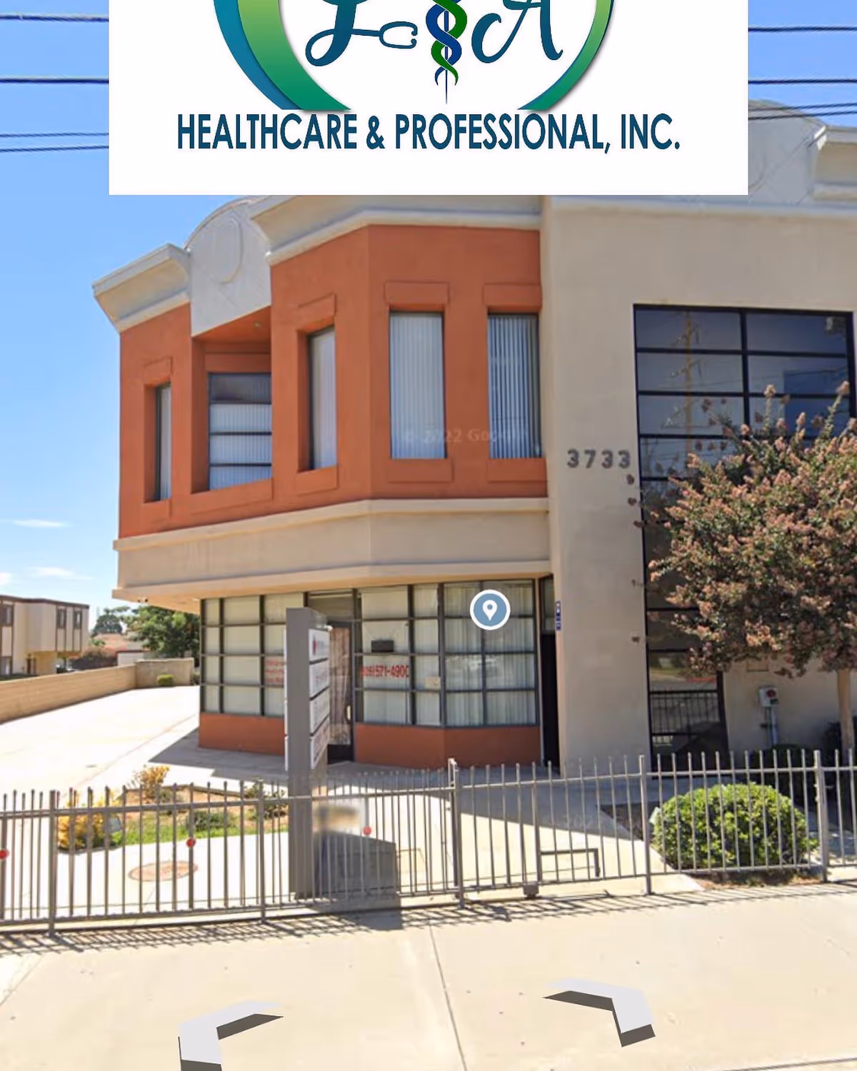 Exterior view of LA Healthcare & Professional, Inc. building with large windows and a gated entrance.