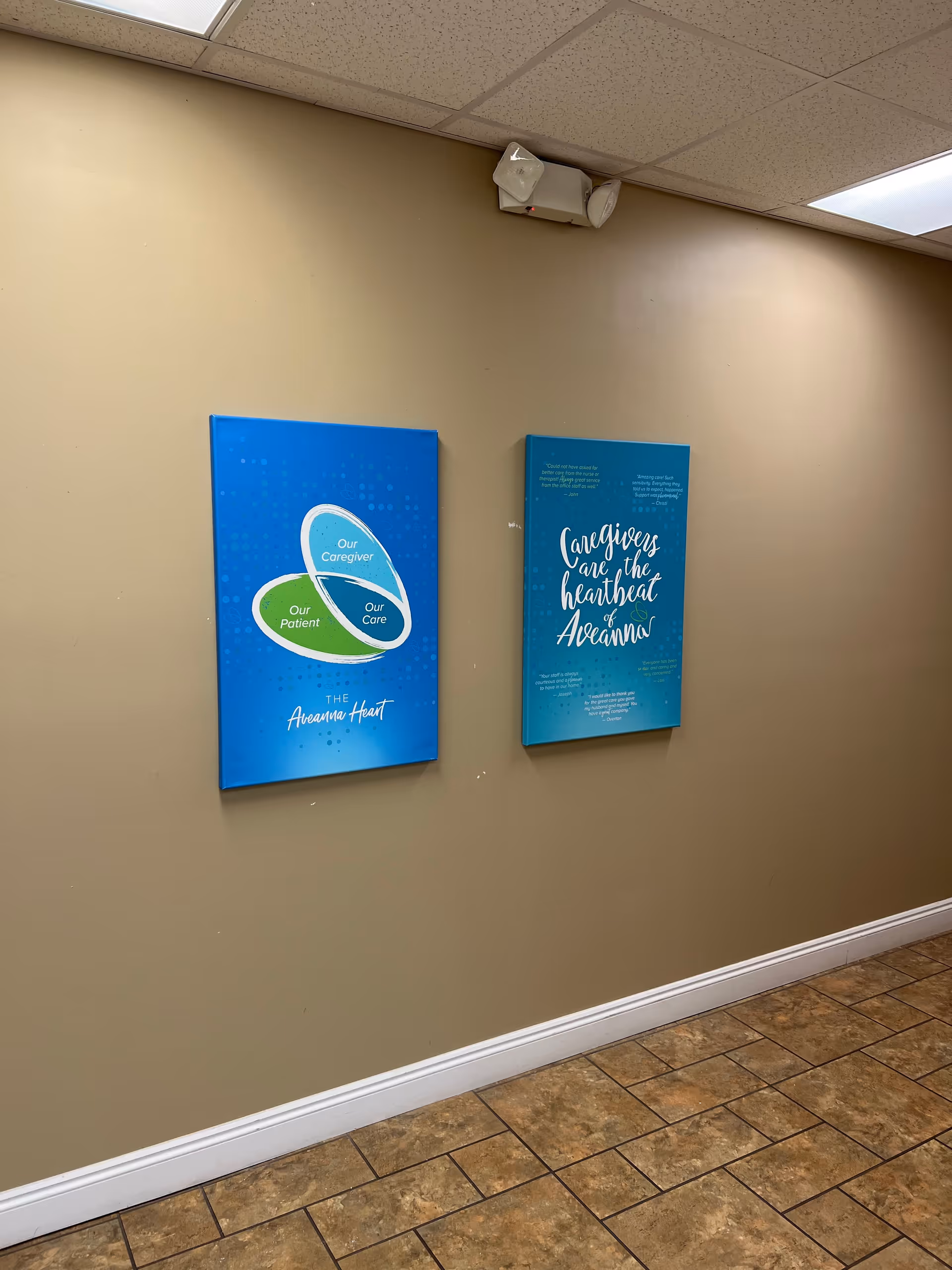 Beige hallway with two blue posters about caregiving mounted on the wall.
