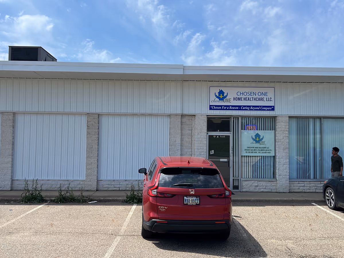 Front view of CHOSEN ONE Home Healthcare storefront with a red SUV parked outside.
