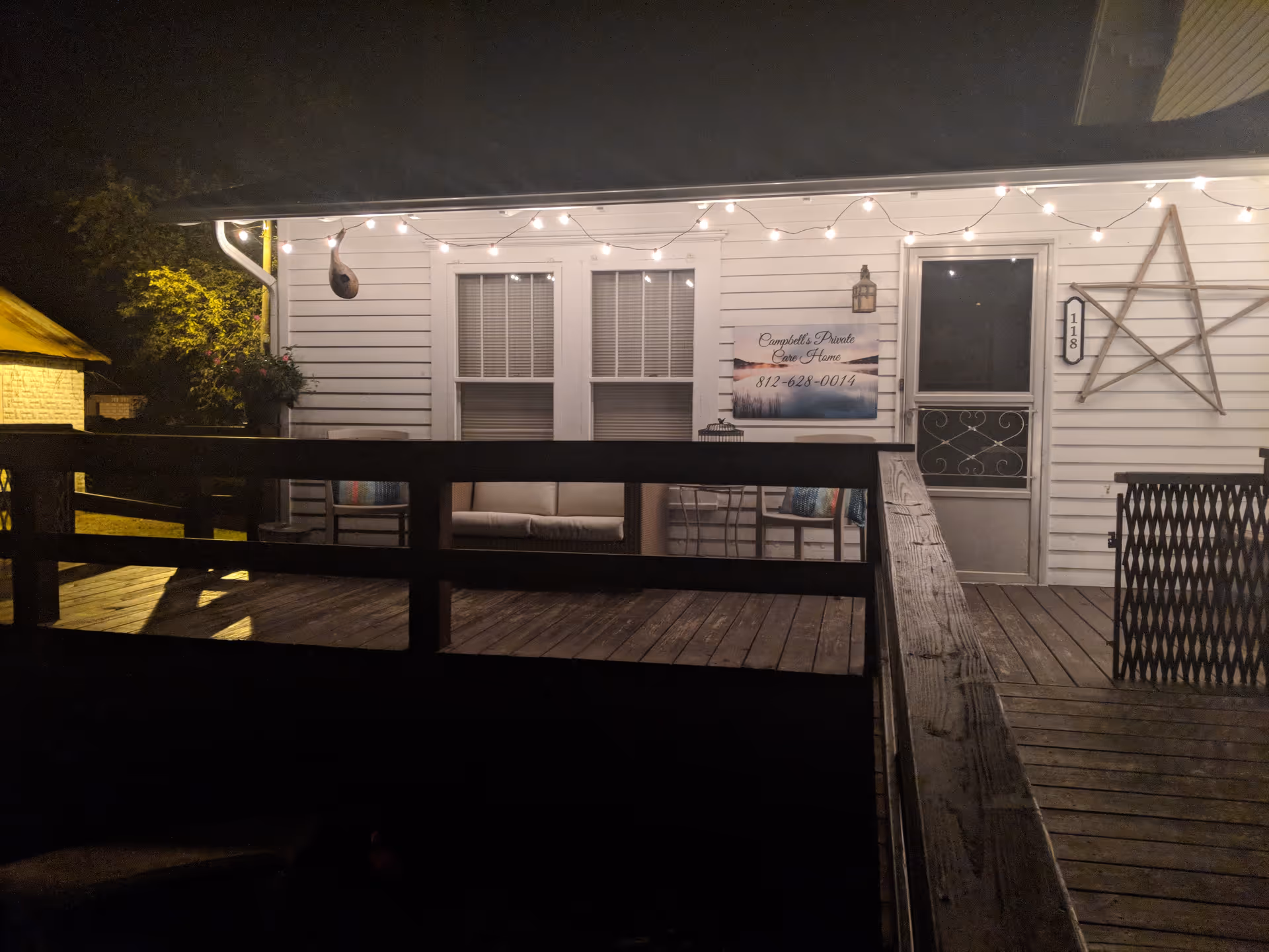 Night exterior of Campbell's Private Care Home porch with string lights.
