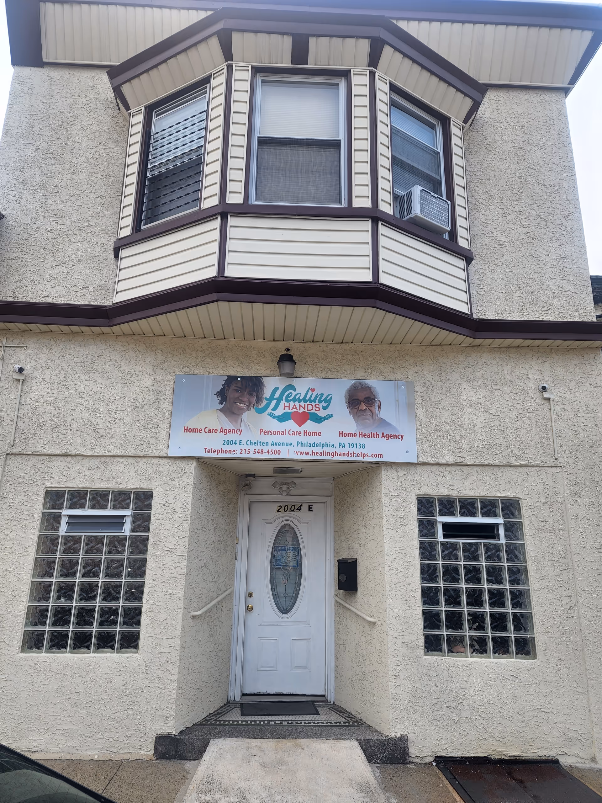 Exterior front of Healing Hands Helps building with sign, bay window, and entrance
