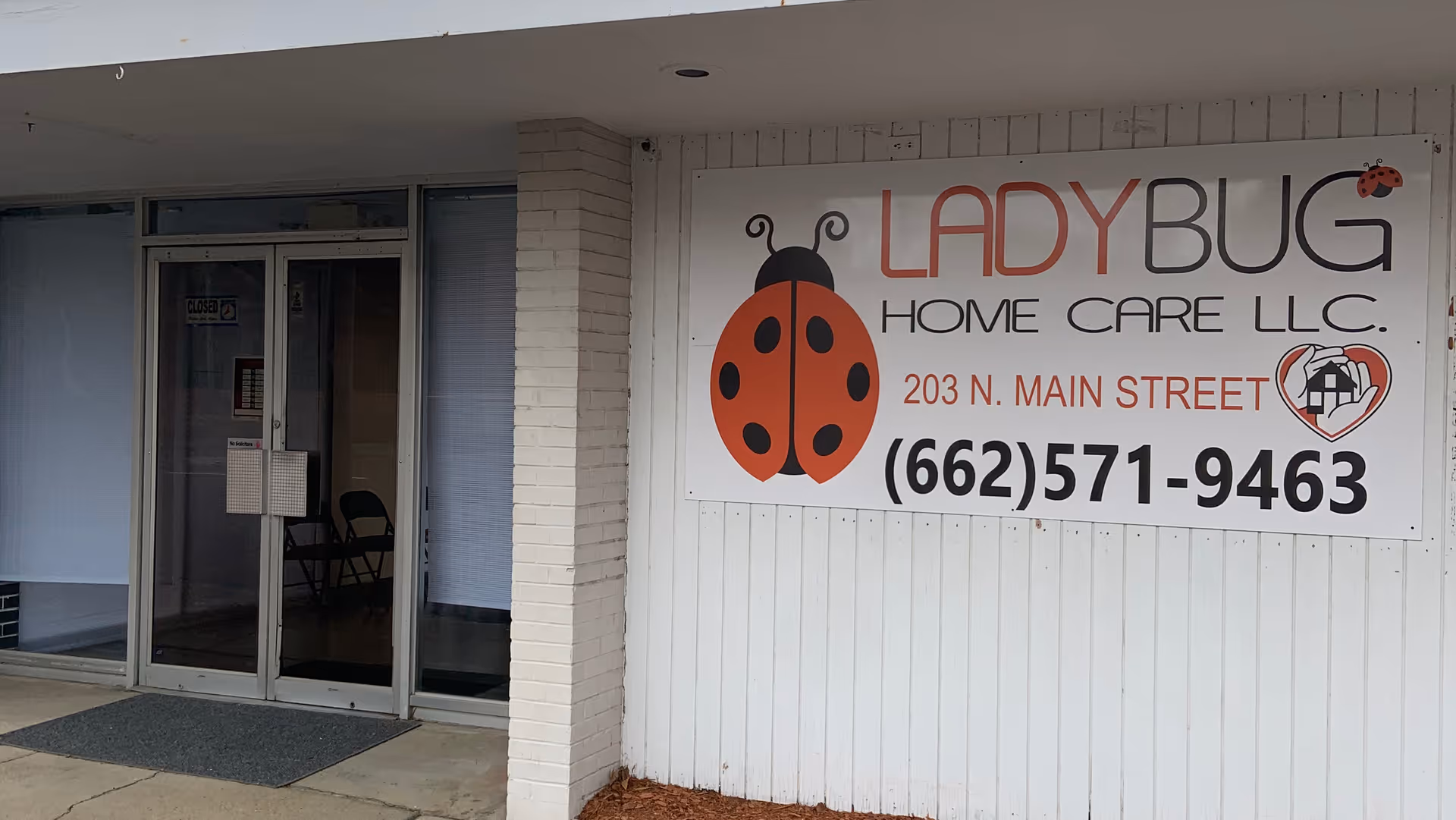 Exterior view of Lady Bug Home Care LLC sign on the building front