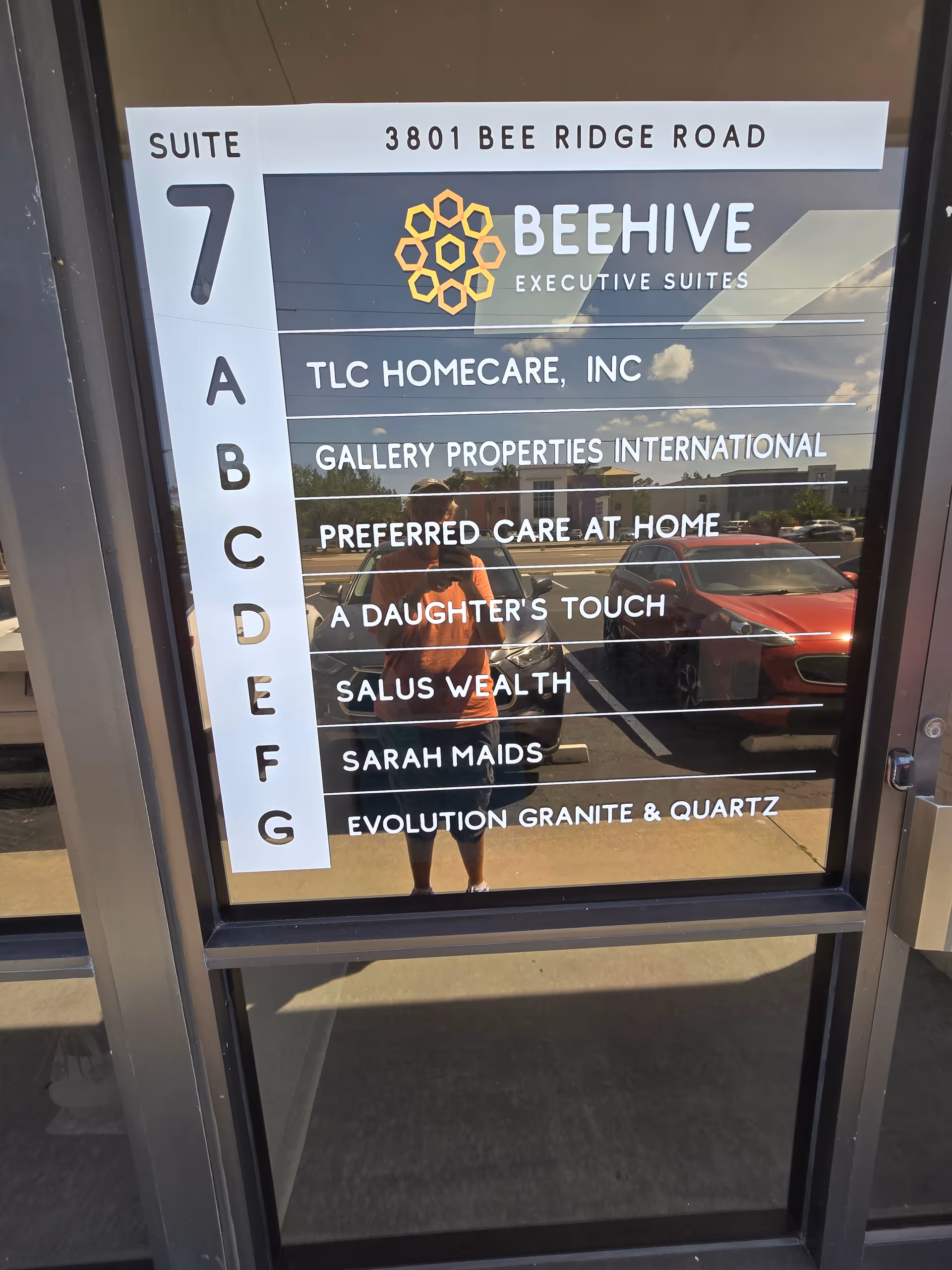 Glass entry door showing a tenant directory with suite names.