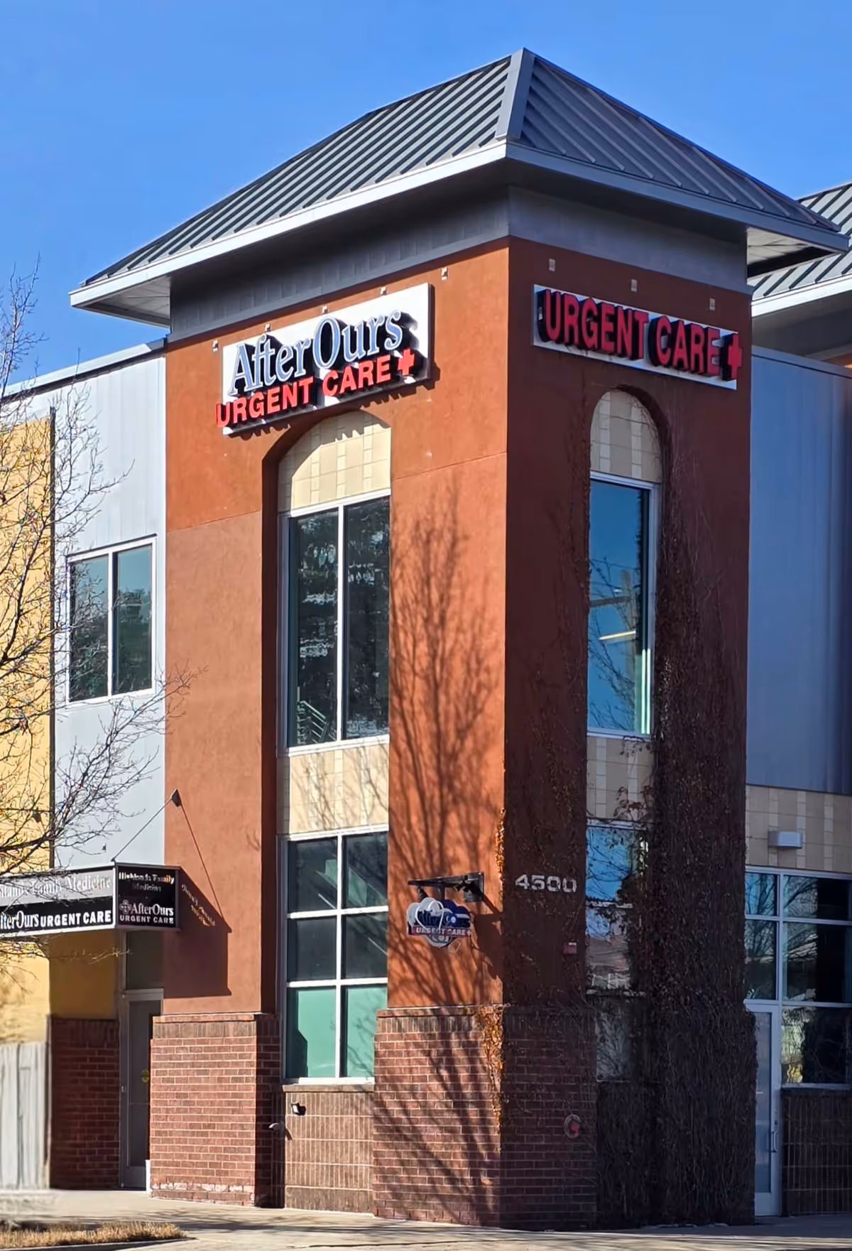 Modern building exterior with AfterOurs Urgent Care signage and tall arched windows