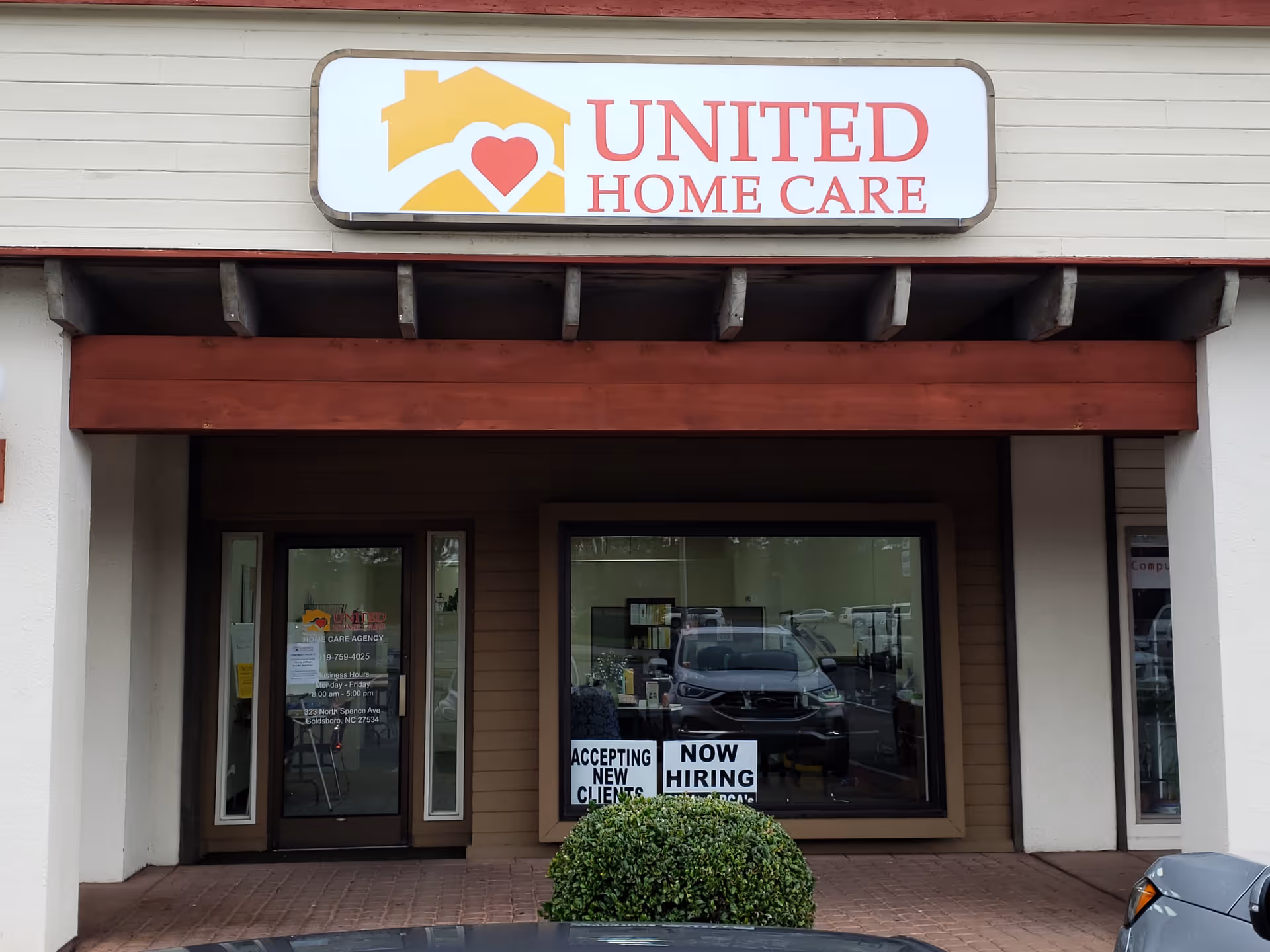 Exterior storefront for United Home Care with logo sign and large front windows.