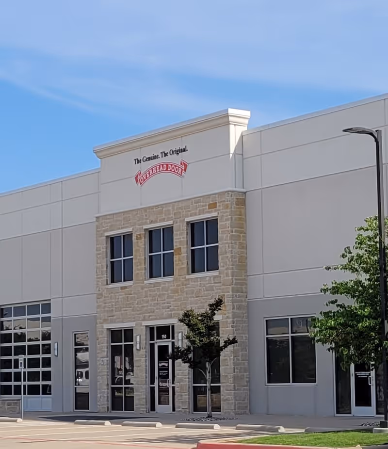 Front view of a modern medical building with stone facade and glass entrances.