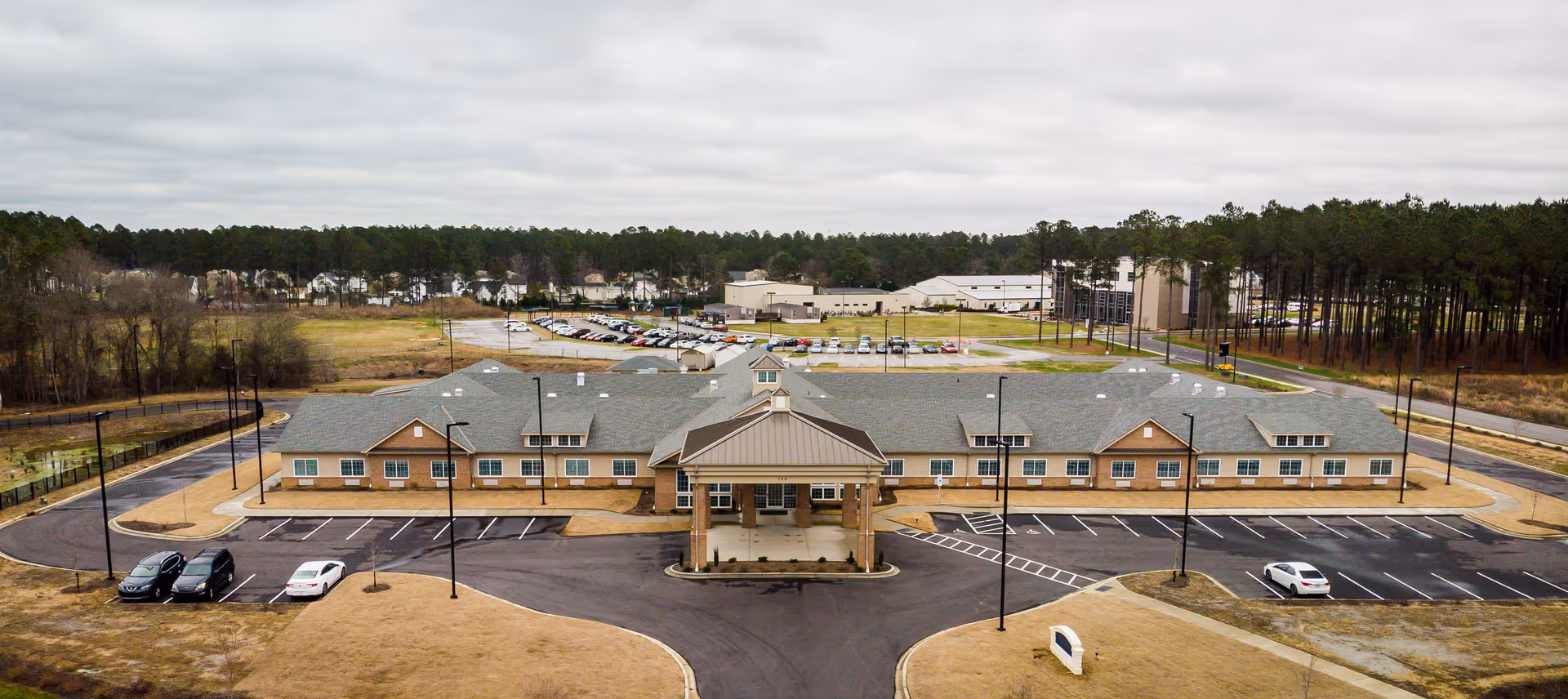 The Landings of Smithfield exterior: a single-story facility with a front entrance and parking.