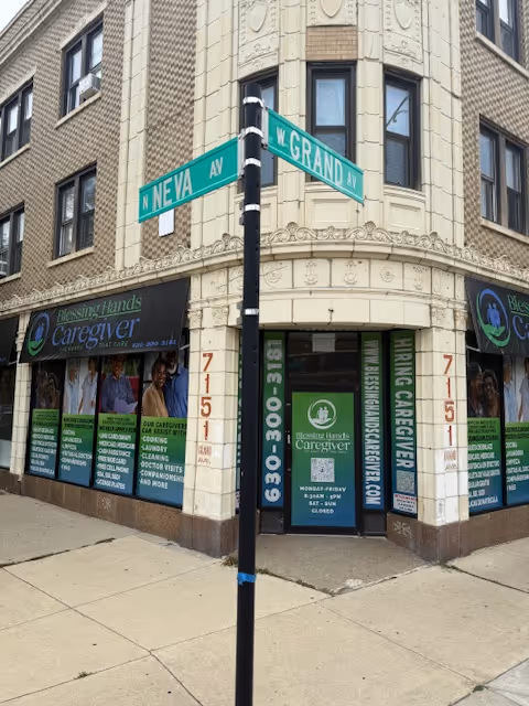 Corner storefront of Blessing Hands Caregiver with banners and street signs.