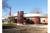 Exterior view of Durand Senior Care and Rehab Center with circular entrance and American flag.