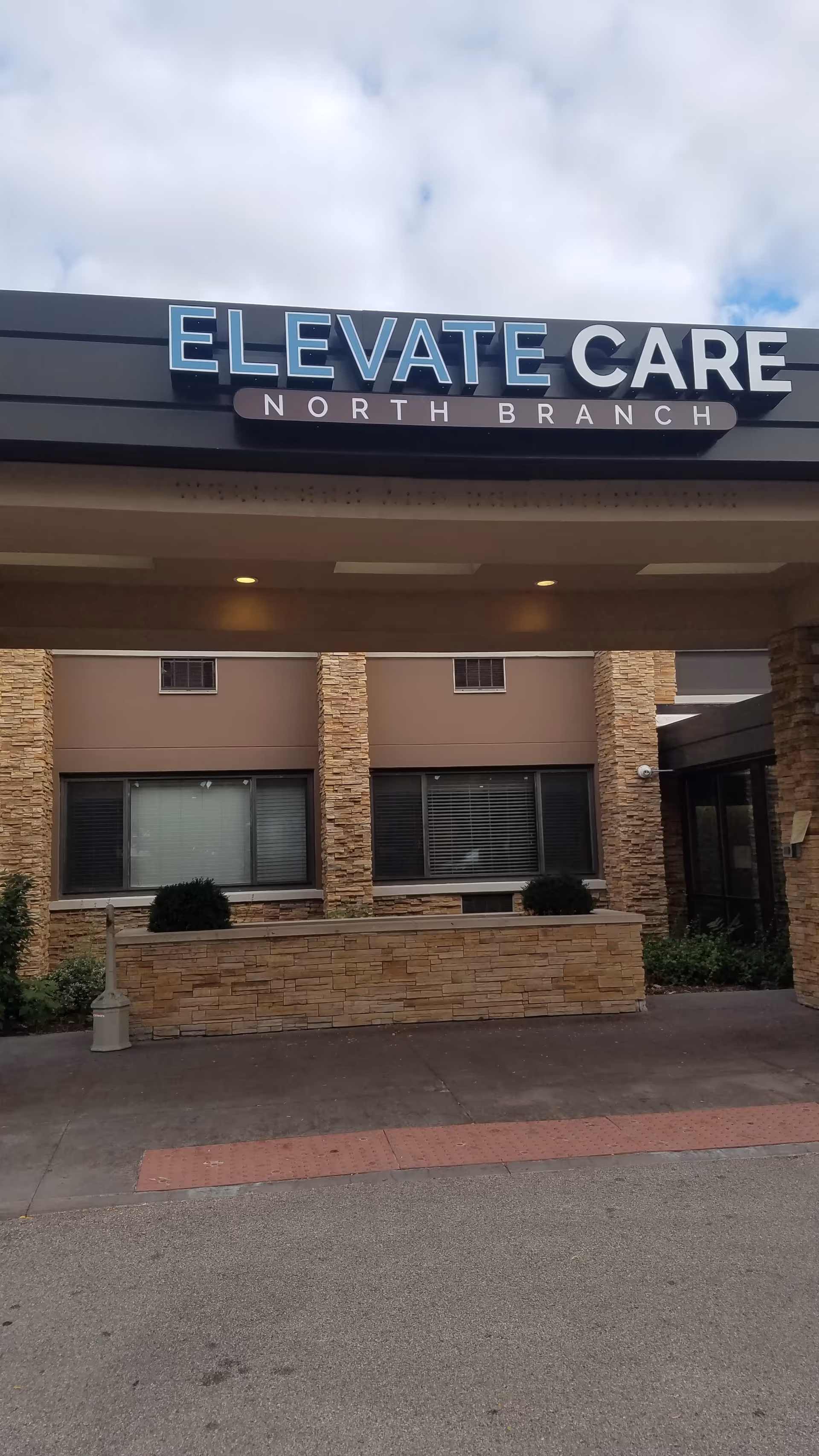 Front exterior of Elevate Care North Branch with sign above entrance