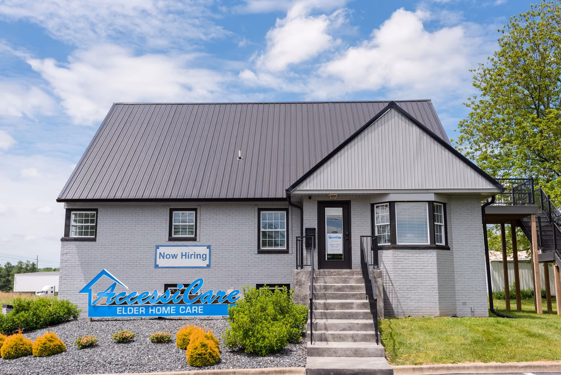 Front exterior of AccessiCare Elder Home Care building with sign and landscaping.