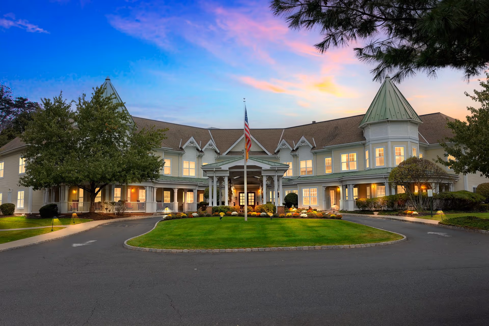 Sunrise of Westfield exterior with entrance, flagpole, and landscaped lawn.