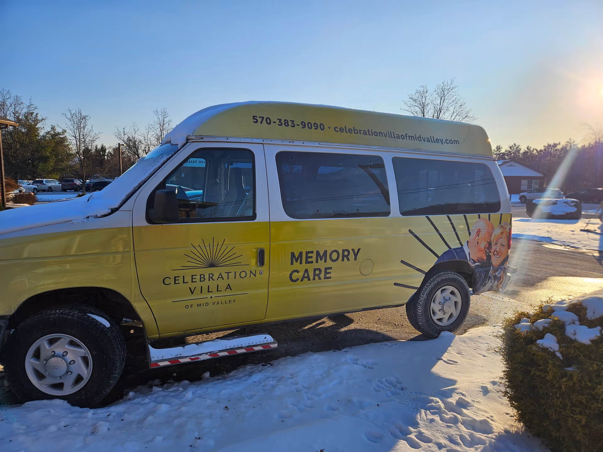 A yellow Celebration Villa memory care van parked in a snow-covered parking lot.