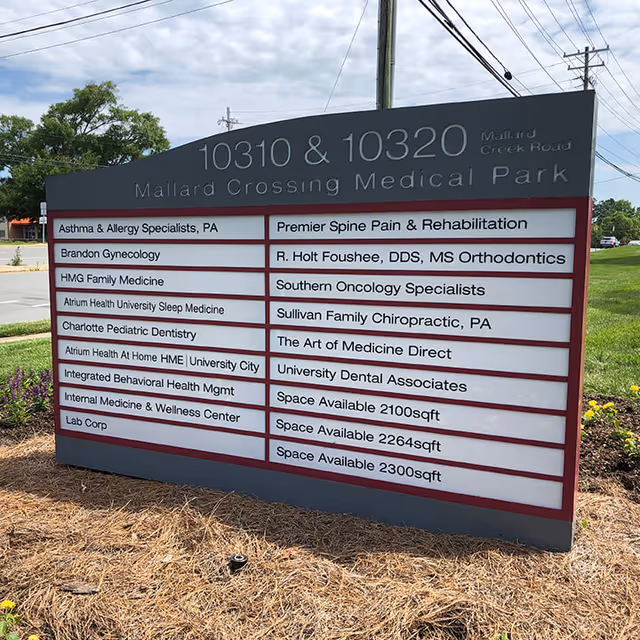 Outdoor signboard listing tenants at Mallard Crossing Medical Park.