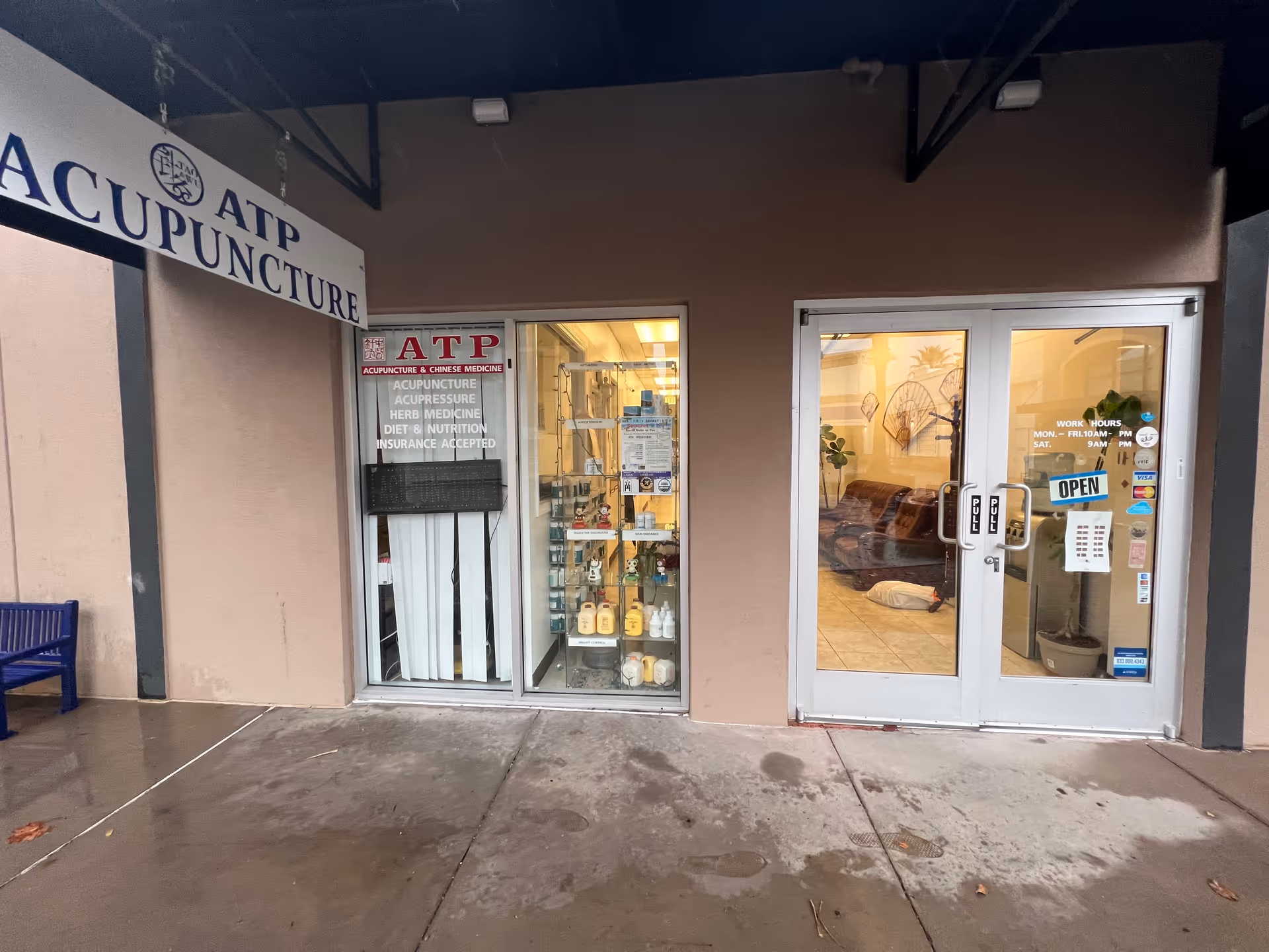Exterior storefront of ATP Acupuncture and Chinese Medicine with glass doors.