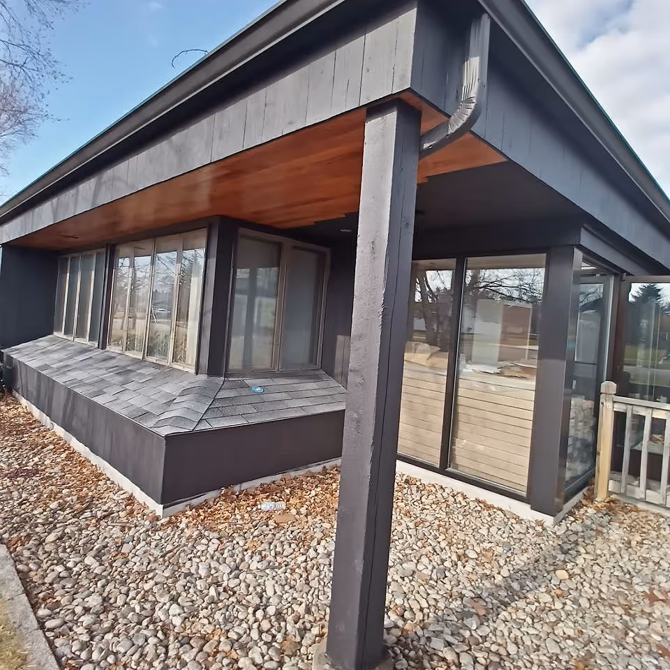 Exterior view of Transition Assisted Living building with glass doors and gravel ground.