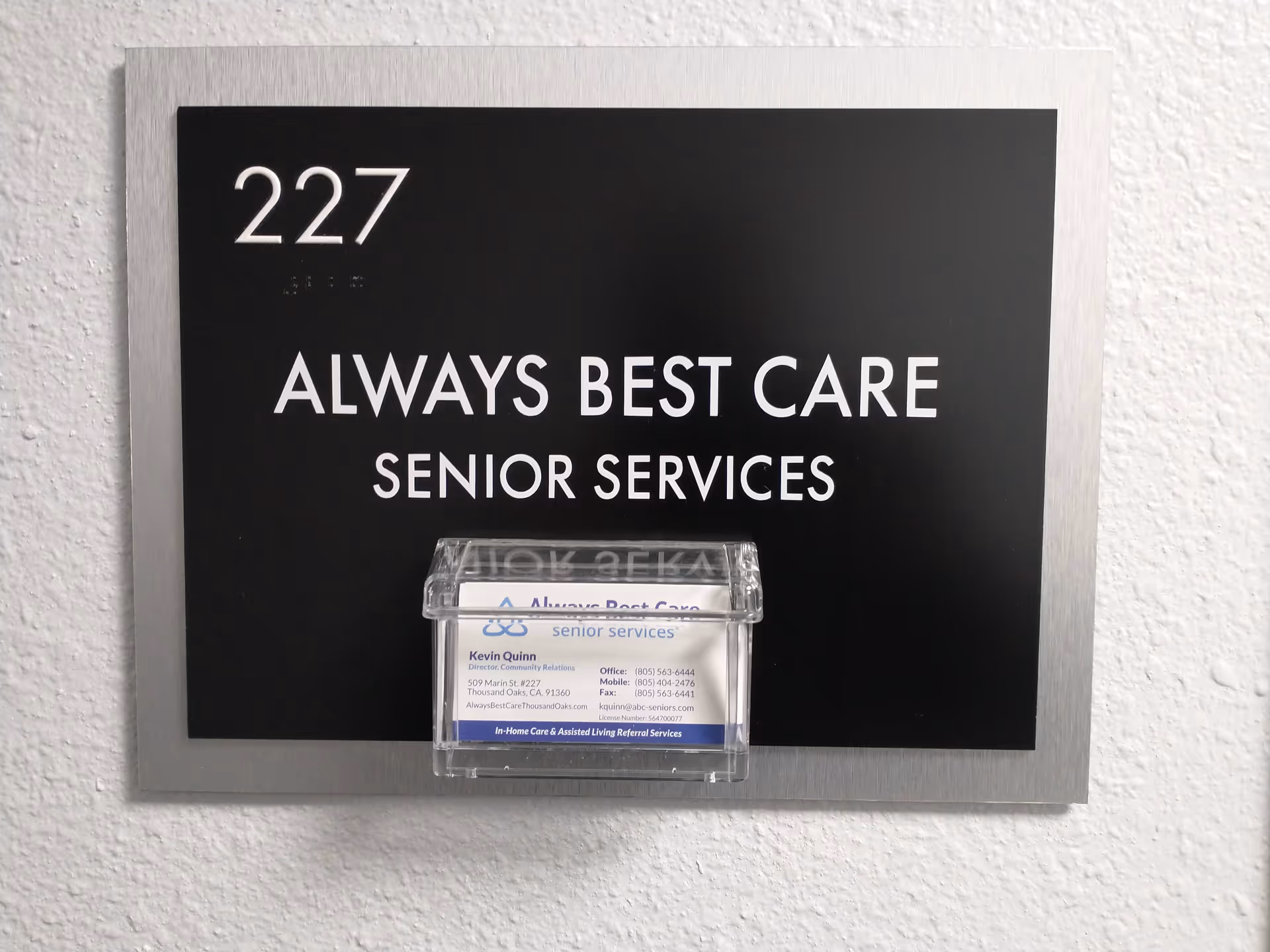 Wall-mounted sign reads Always Best Care Senior Services with a small information card.