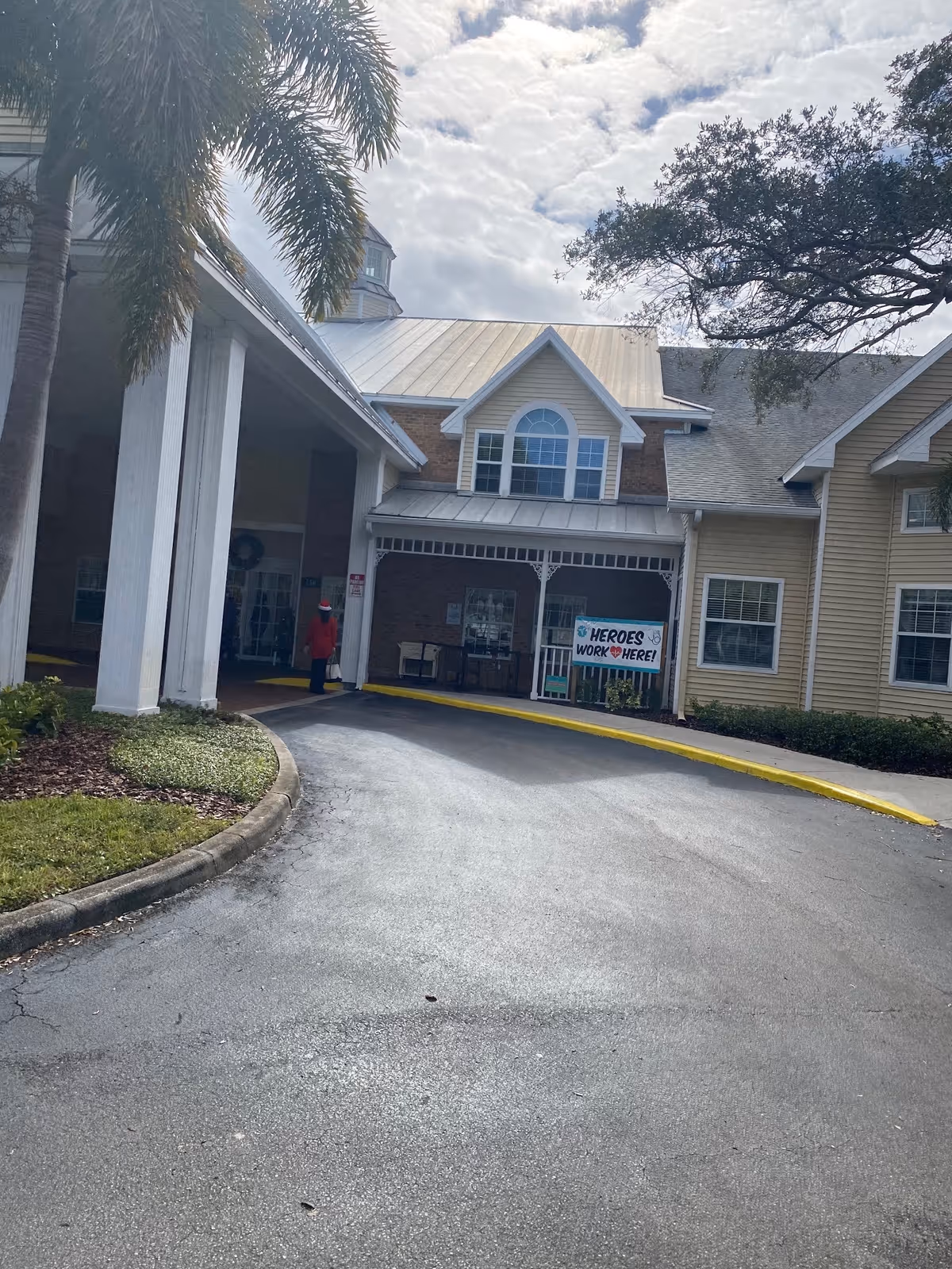 Front exterior of Volante of Largo showing driveway, entrance, and a sign by windows.