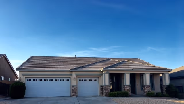 A single-story beige facility exterior with a three-car garage, stone accents, and front columns.