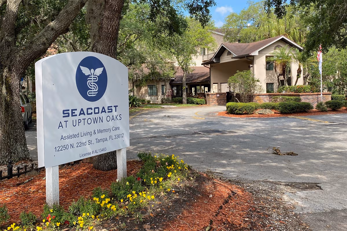 Exterior view of SeaCoast at Uptown Oaks entrance with sign and landscaping.