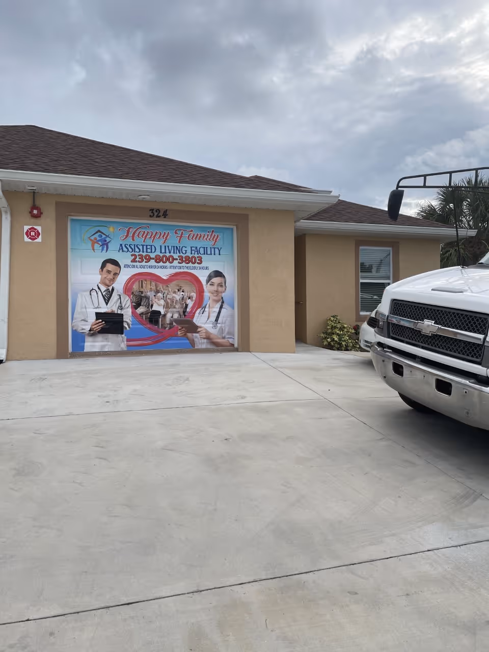 Front view of Happy Family Assisted Living Facility with large sign