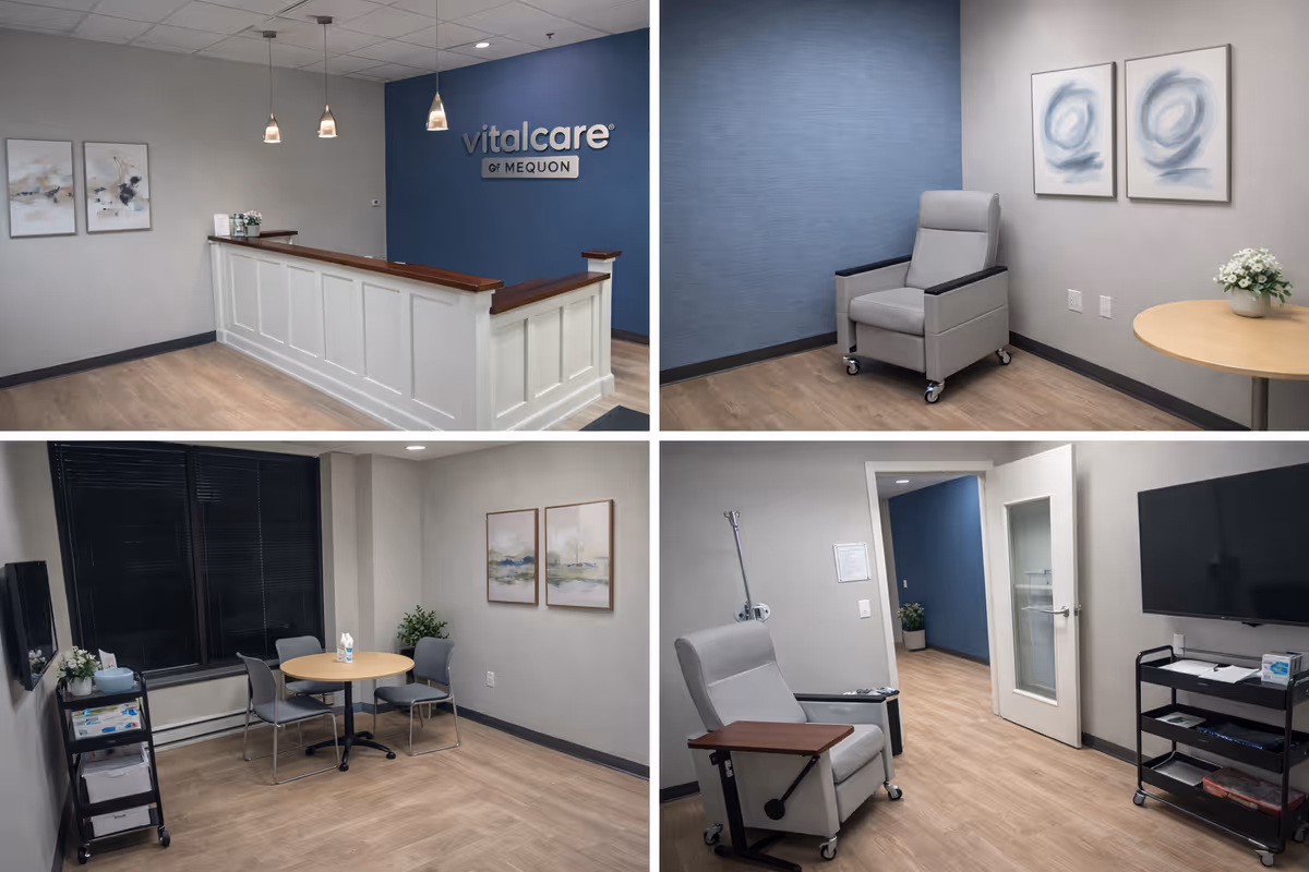 Reception area with a white front desk, blue wall, and seating in a medical facility.