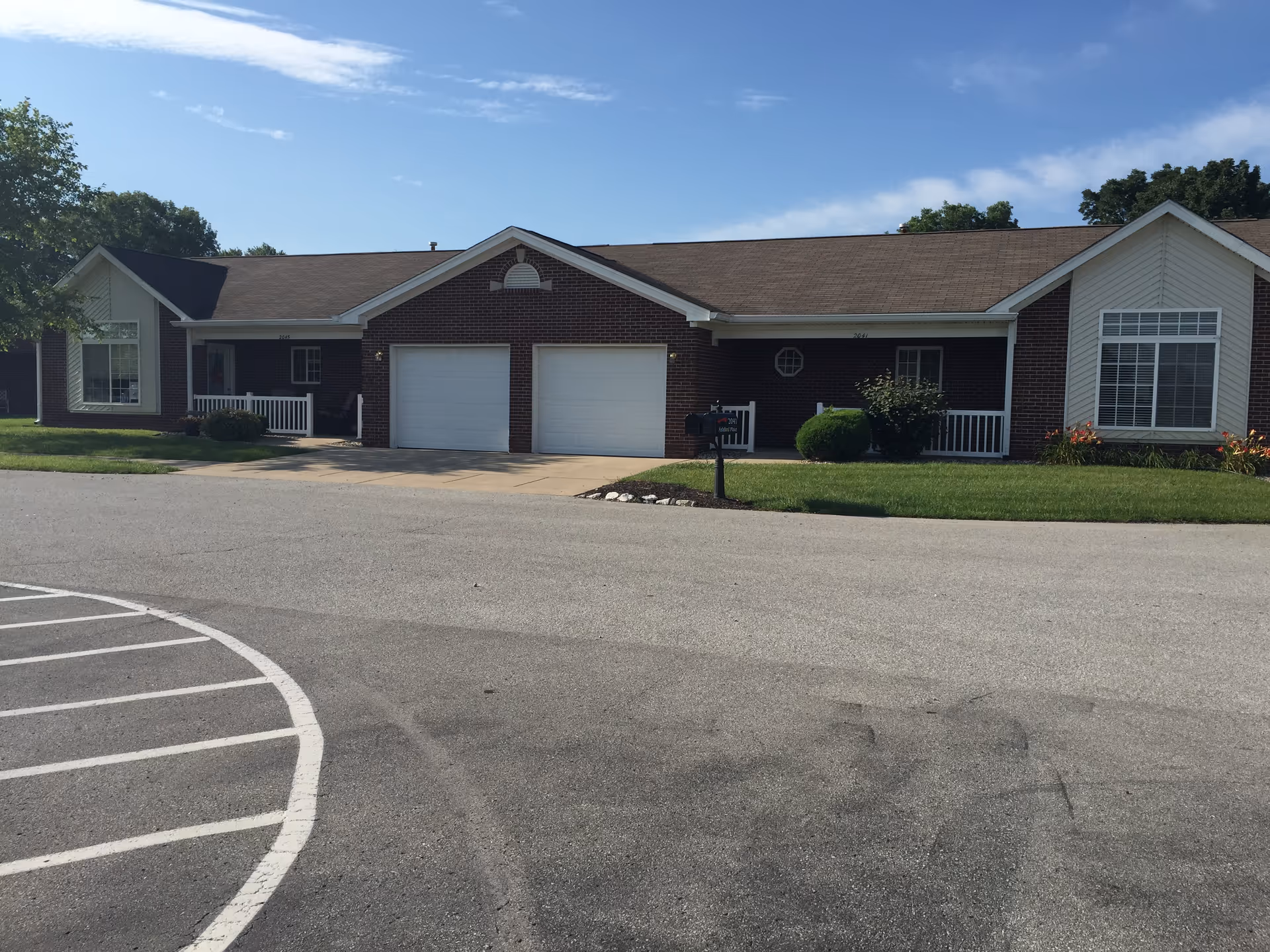 Ashford Place Health Campus exterior: brick building with garages and manicured lawn