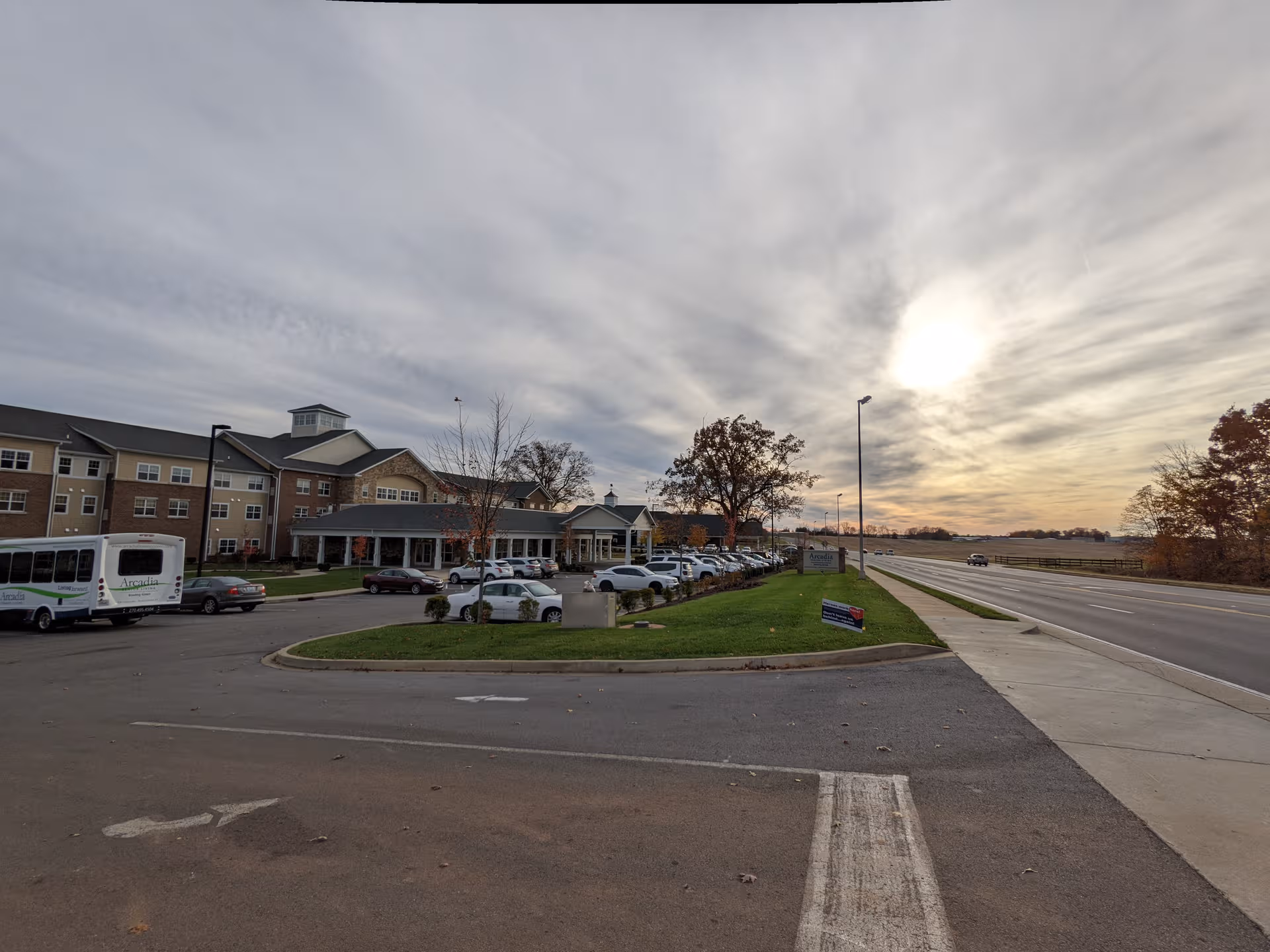 Exterior view of Arcadia Senior Living Bowling Green showing the building, parking lot, and entrance.