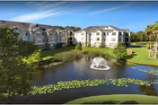 Endwell Homes senior living complex features a pond with a fountain and surrounding green landscaping.