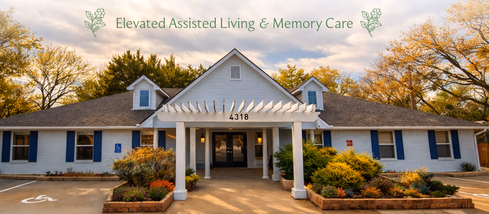 Front view of a single-story assisted living building with landscaped entrance and welcoming awning.