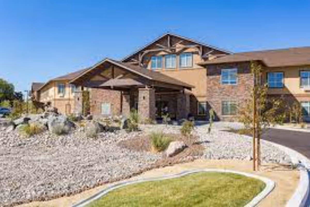 Front exterior of Volante Senior Living of Reno with landscaping and stone facade.