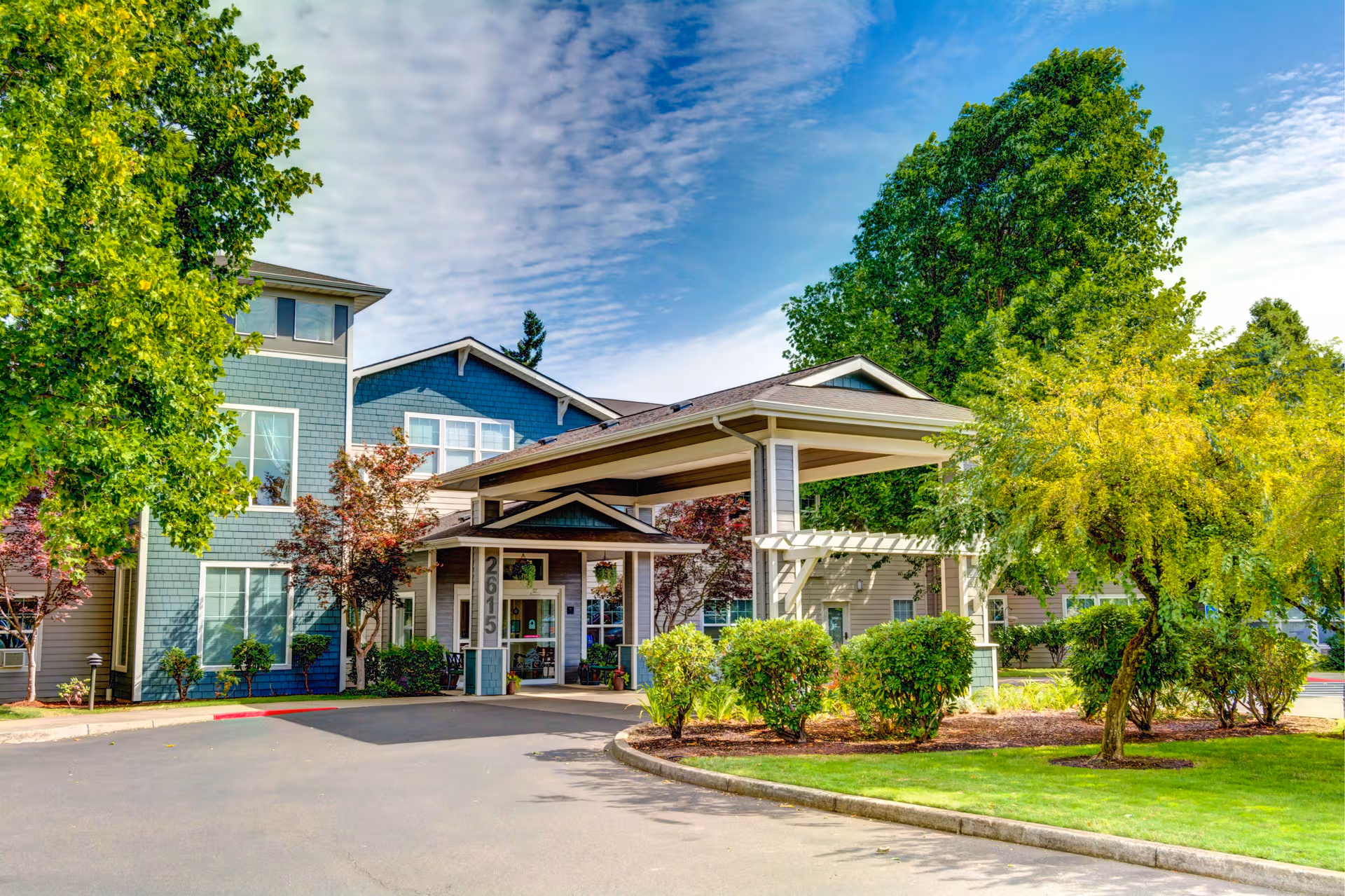 Front exterior view of Lone Oak Assisted Living with entrance canopy and landscaping.
