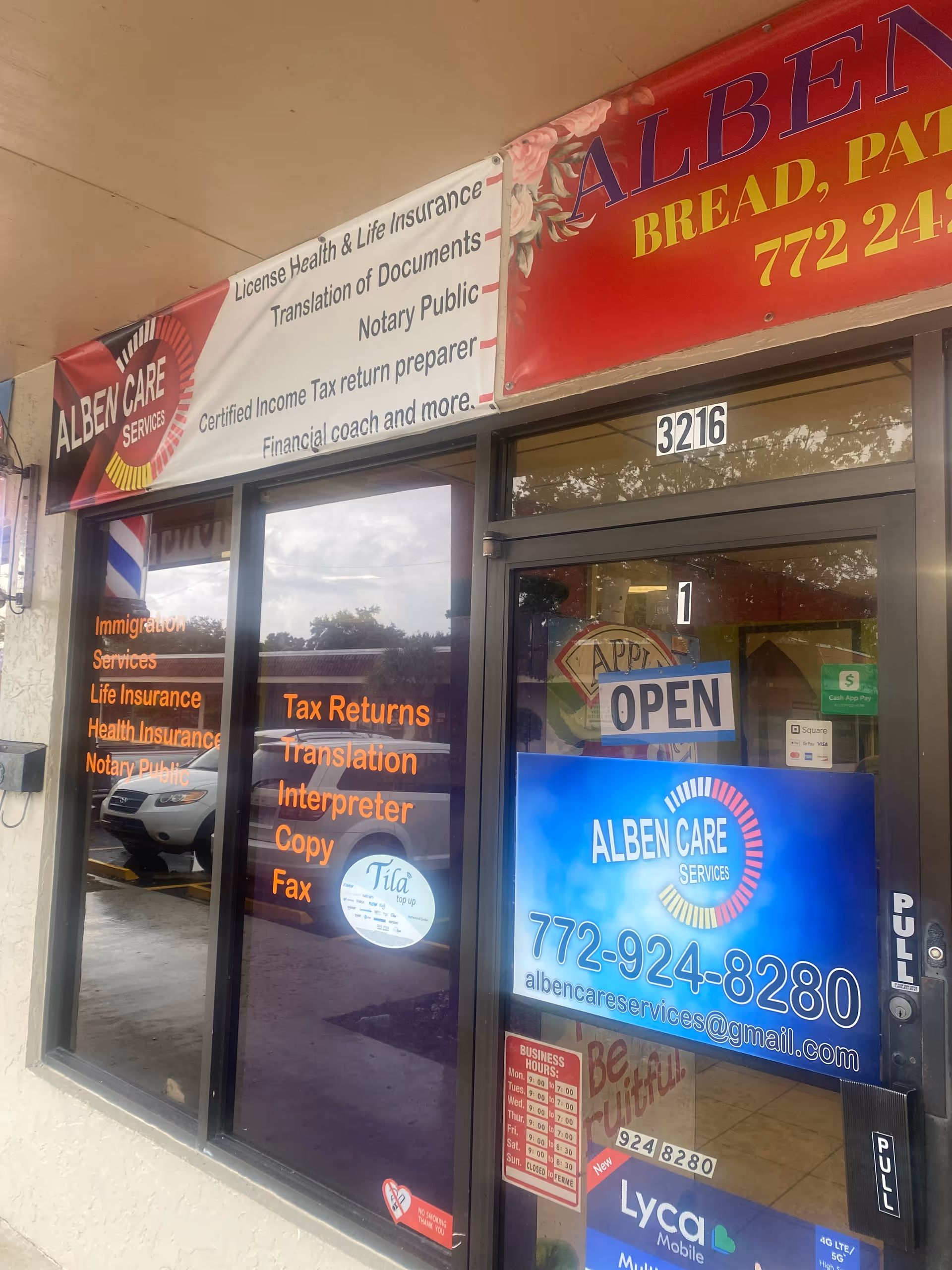 Exterior storefront of Alben Care Services with banners and an 'OPEN' sign.