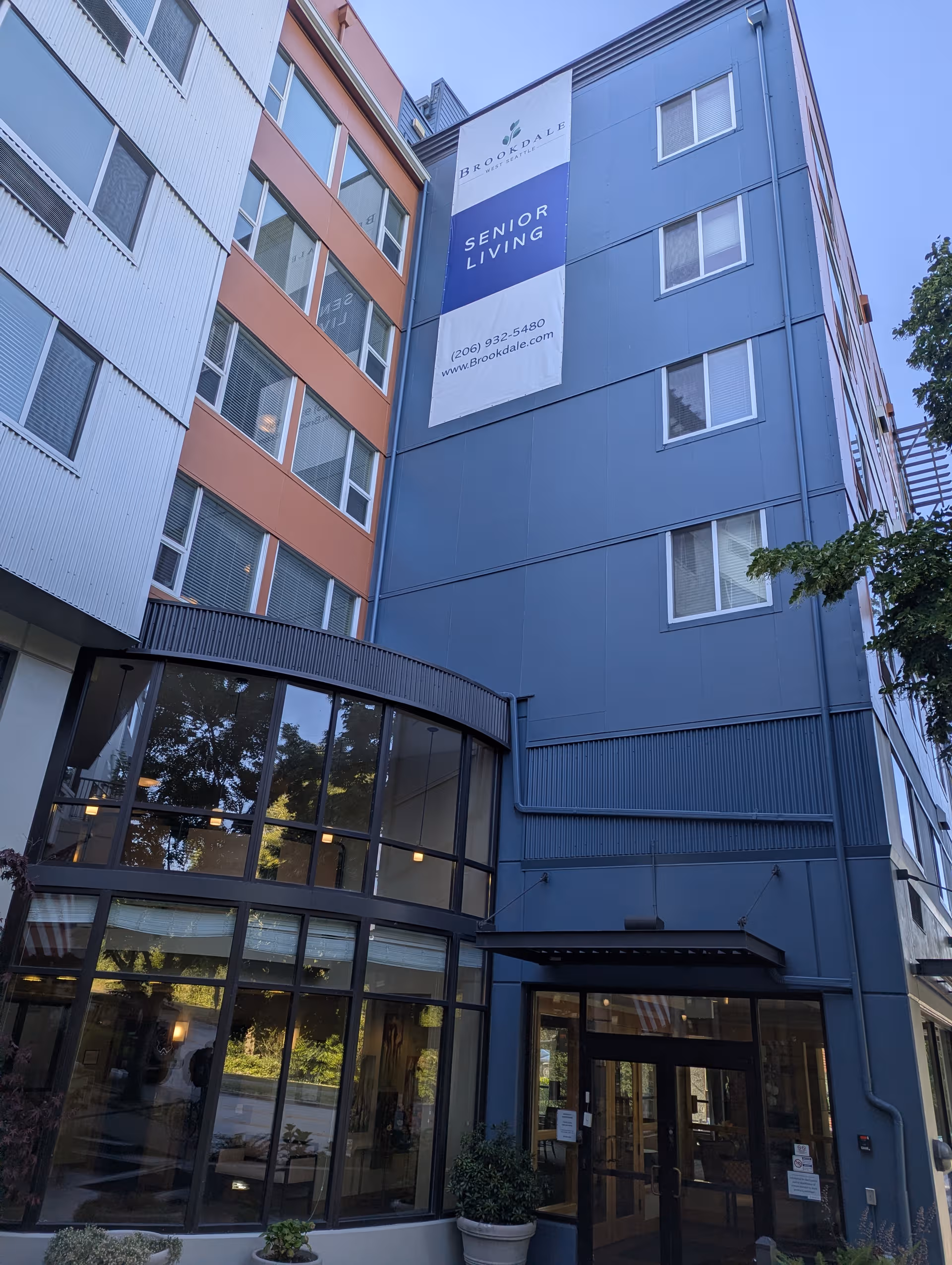 Tall multi-story building with Brookdale Senior Living banner and glass front entrance.