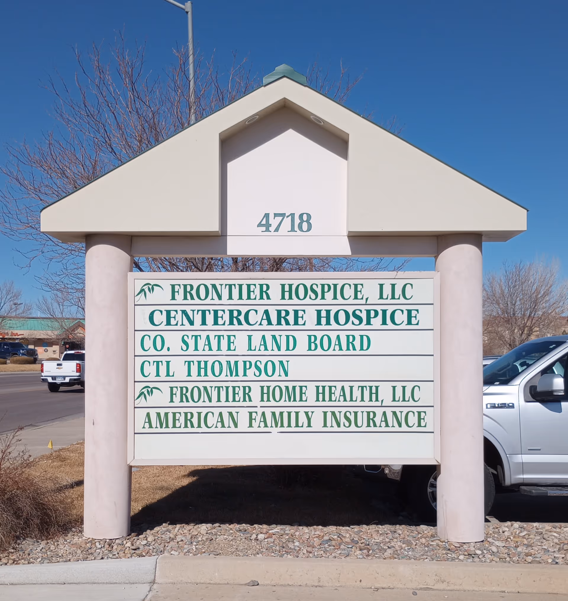 Exterior sign with address 4718 listing Frontier Hospice and related services.