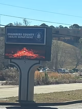 Exterior sign for Chambers County Health Department in front of a building.