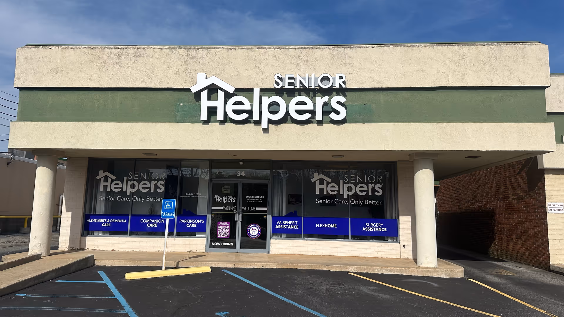 Front of Senior Helpers building with prominent sign and glass entrance.