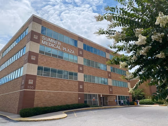 Three-story brick medical plaza exterior with multiple windows and a front entrance.